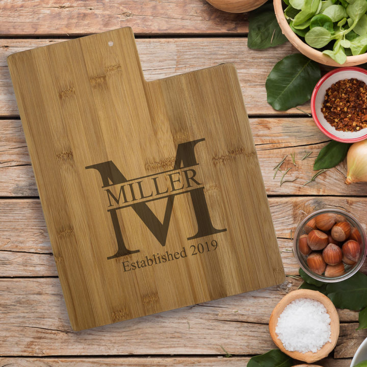 utah state personalized engraving bamboo cutting board on wood table besides vegetables