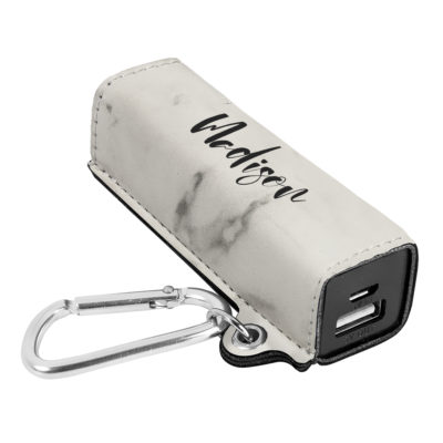 power bank on top of black table next to smartphone