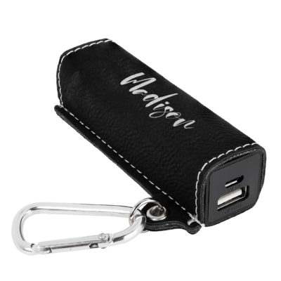power bank on top of black table next to smartphone