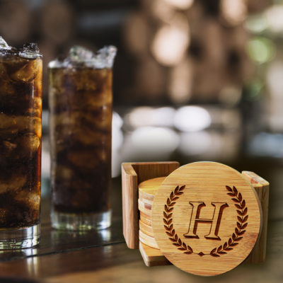 round bamboo coaster set on top of table next to cold drinks