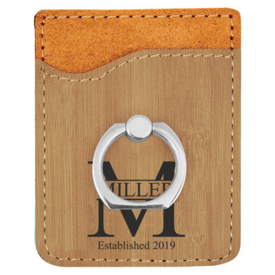 faux leather phone wallet with ring holder on top o keyboard next to coffee cup