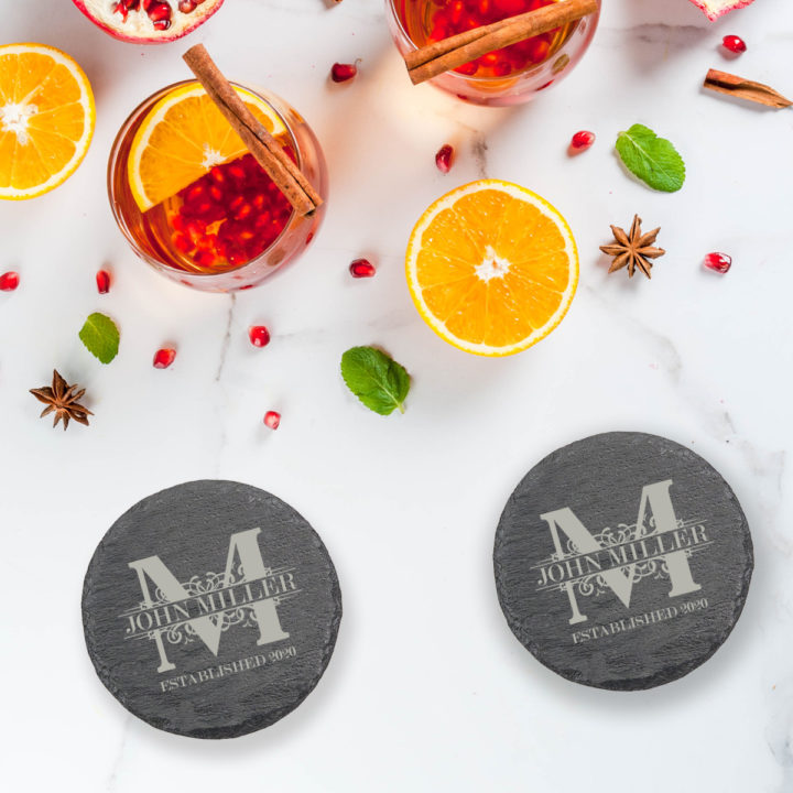 round slate coasters on top of white table next to cold drinks