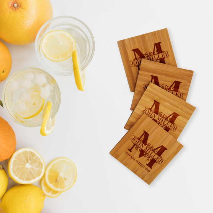 square bamboo coasters on table besides cold glasses of lemonade